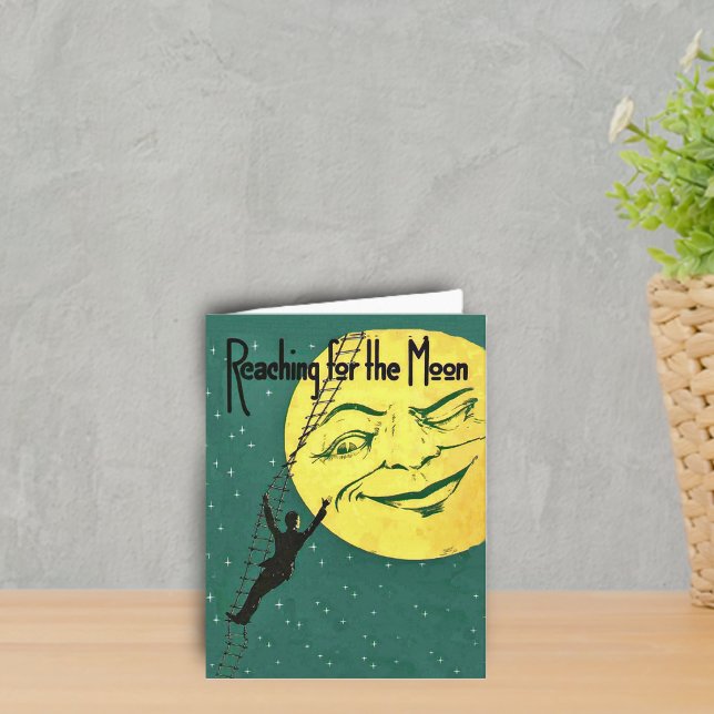 Atteindre pour la carte Moon Note (Man climbing ladder to reach yellow winking moon with face on emerald green with stars notecard.)