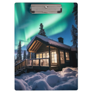 Aurora borealis over winter cabin clipboard