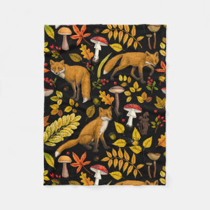 Autumn foxes on black fleece blanket