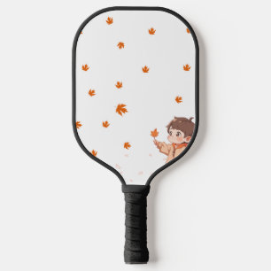 Autumn leaf held by a cute little boy pickleball paddle