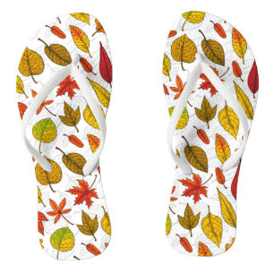 Autumn leaves on white flip flops