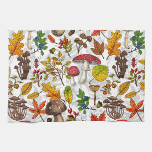Autumn mushrooms, leaves, nuts and berries on blue kitchen towel