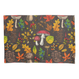 Autumn mushrooms, leaves, nuts and berries on blue pillowcase