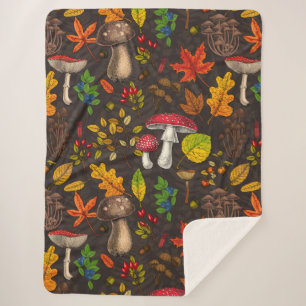 Autumn mushrooms, leaves, nuts and berries on blue sherpa blanket
