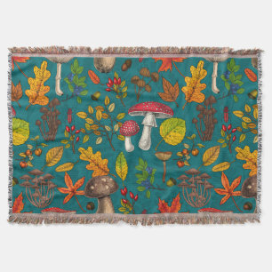 Autumn mushrooms, leaves, nuts and berries on blue throw blanket