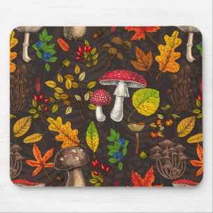 Autumn mushrooms, leaves, nuts and berries on dark mouse pad