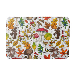 Autumn mushrooms, leaves, nuts and berries on whit bath mat