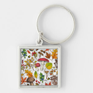 Autumn mushrooms, leaves, nuts and berries on whit keychain