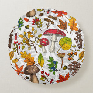 Autumn mushrooms, leaves, nuts and berries on whit round pillow