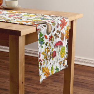 Autumn mushrooms, leaves, nuts and berries on whit short table runner