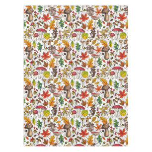 Autumn mushrooms, leaves, nuts and berries on whit tablecloth