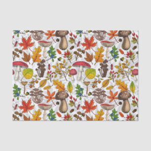 Autumn mushrooms, leaves, nuts and berries on whit tissue paper