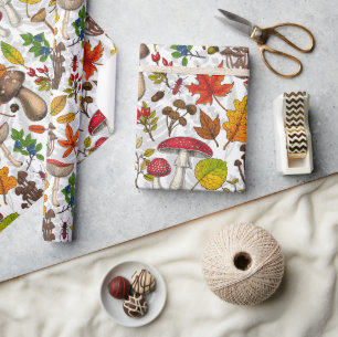 Autumn mushrooms, leaves, nuts and berries on whit wrapping paper