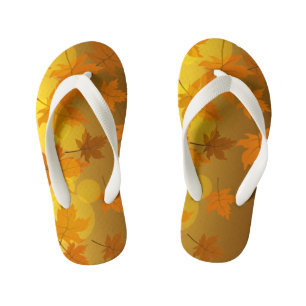 Autumn pattern with falling maple leaves and bokeh kid's flip flops
