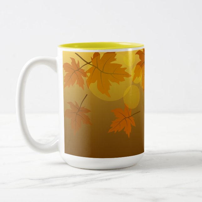 Autumn pattern with falling maple leaves and bokeh Two-Tone coffee mug (Left)