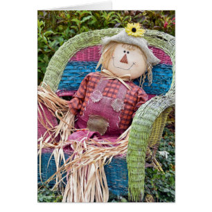 Autumn scarecrow in wicker chair