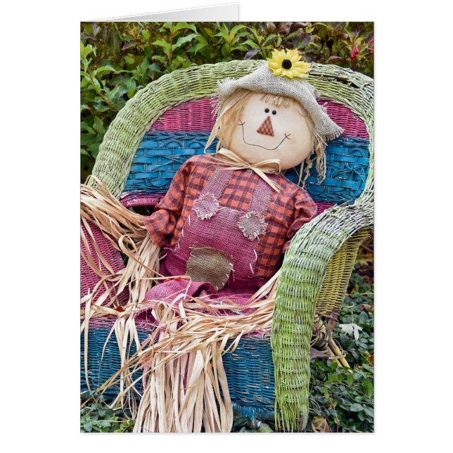 Autumn scarecrow in wicker chair (Front)