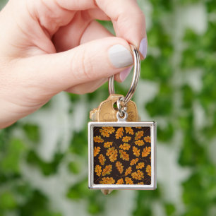 Autumnal oak leaves on dark brown keychain