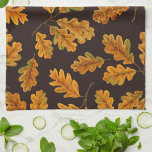Autumnal oak leaves on dark brown kitchen towel