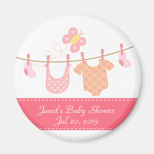 Baby clothes hanging on clothesline with butterfly magnet