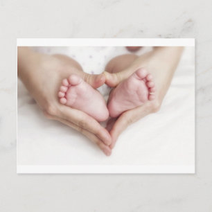 Baby feet in mother hands postcard