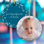 Baby First Hanukkah Stars Snowflakes Grandparents Ceramic Ornament<br><div class="desc">“First Hanukkah.” A playful visual of white Stars of David, snowflakes and handwritten script typography with customized year, overlaying the photo of your choice, help you usher in Hanukkah and New Year. On the back, additional white Stars of David, snowflakes and handwritten typography with “proud grandparents of baby’s name” overlay...</div>