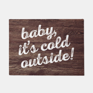 baby, it's cold outside! on dark wood background doormat