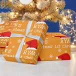 Baby`s First Christmas Red Santa Hat Snowflake Wrapping Paper<br><div class="desc">Baby`s First Christmas Red Santa Hat Snowflake Wrapping Paper. Celebrate Baby's very first Christmas with this adorable personalized wrapping paper! Featuring a festive design with a cute Santa hat, and delicate snowflakes on a warm orange background, this unique gift wrap adds a special touch to all presents. Make first holiday...</div>