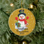 Baby's First Christmas cute snowman black hat  Ceramic Ornament<br><div class="desc">A whimsical Christmas tree ornament featuring an adorable snowman surrounded by delicate snowflakes. Customize it with your child's name and the year for a personalized touch that captures the joy of the season.
Use the "Personalize" button to customize to your liking.</div>