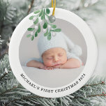 Baby's First Christmas Photo Ceramic Ornament<br><div class="desc">This Baby's First Christmas Ornament is decorated with watercolor mistletoe.
Easily customizable with your baby's photo,  name,  and year.
Use the Design Tool to change the text size,  style,  or colour.
Original Watercolor © Michele Davies.</div>