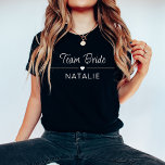 Bachelorette Party Team Bride Personalized Bridal T-Shirt<br><div class="desc">Elevate your bachelorette party style with our Team Bride Personalized Bridal T-Shirt in a chic and bold dark colour, adorned with striking white prints. Designed for the bride and her squad, these dark-coloured shirts add a touch of sophistication to your celebration while maintaining a sense of fun and unity. The...</div>