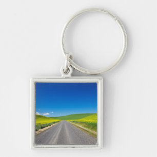 Backcountry road through Spring Canola Fields Keychain