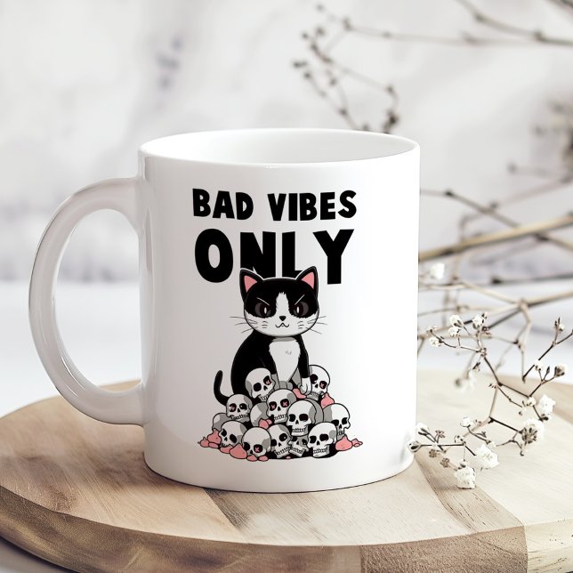 "Bad Vibes Only" Funny Angry Cat Coffee Mug ("Bad Vibes Only" Funny Angry Cat Coffee Mug on a boho kitchen table with tiny white flowers)