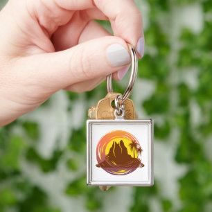 Badge with tropical volcano scenery and palm trees keychain