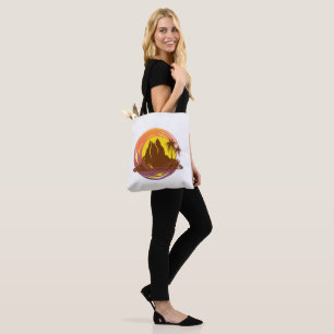 Badge with tropical volcano scenery and palm trees tote bag