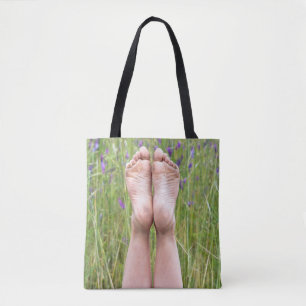 bare feet in wildflowers tote bag