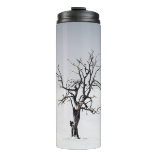 BARE TREE IN THE MIDDLE OF SNOW THERMAL TUMBLER