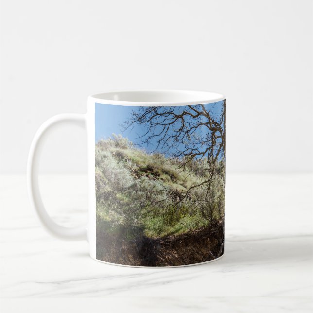 Bare tree on mountain during day coffee mug (Left)