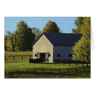 Barn on thoroughbred horse farm at sunrise,