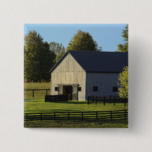 Barn on thoroughbred horse farm at sunrise, 2 inch square button