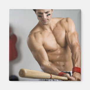 Baseball player with bare chest warming up with magnet