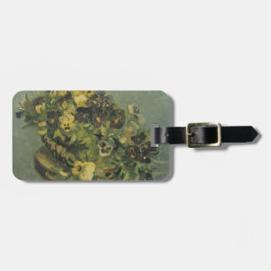 Basket of pansies on a small table luggage tag