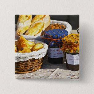 Basket with croissants and chocolate breads. 2 inch square button