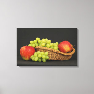 Basket with fruits on dark table canvas print