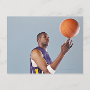 Basketball player balancing ball on one finger postcard