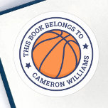 Basketball this book belongs to school name classic round sticker<br><div class="desc">Basketball book labels featuring a basketball at the centre and customizable text "this book belongs to" and your name in a college sports style font. All colours are customizable in the design tool.</div>