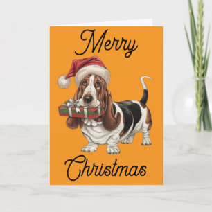 Basset Hound in Santa hat present in mouth Card