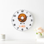Be a Bagel Funny Food Pun Bagel Lover Design  Large Clock<br><div class="desc">Add a touch of humour to your space with this “Be a Bagel” wall clock. Featuring a playful bagel illustration and a witty pun, this clock is perfect for food lovers, brunch enthusiasts, and anyone who enjoys quirky decor. Made with high-quality materials and a sleek design, it’s a fun and...</div>