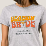 Beach Bachelorette Party Retro Beachin Bride T-Shirt<br><div class="desc">Make a splash at your upcoming bachelorette party with this stunning beach bachelorette party personalized t-shirts. Whether you're celebrating a bach trip, a girls' vacation, or a best friends' holiday, this custom beach bachelorette party t-shirts are the perfect addition to your unforgettable getaway. Add a personal touch to your bachelorette...</div>