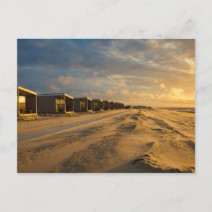 Beach cabins at sunset at the dutch coast postcard